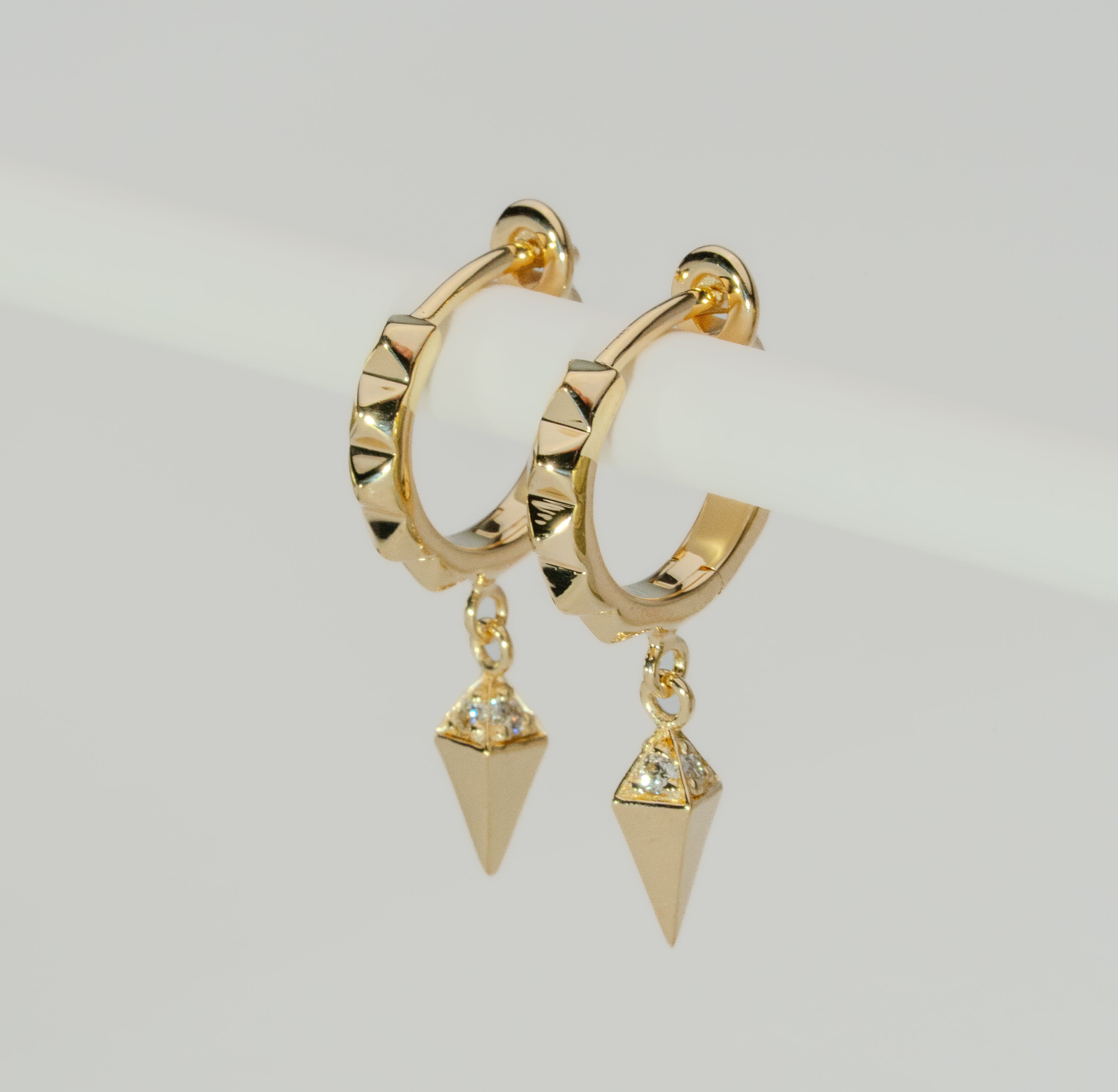 Unisex Ekati diamond earrings. Hoop dangle style. Earth Collection natural diamonds diamonds set in Modern Electrum™.