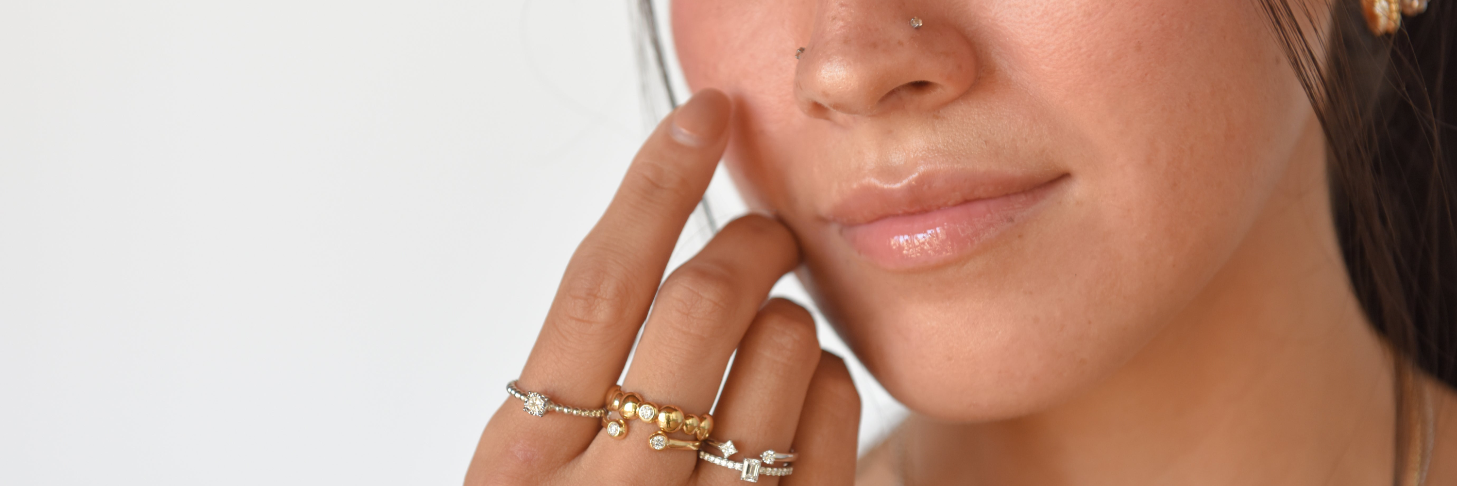 Unisex natural diamond rings stacked on female hands featuring trendy diamonds that glow