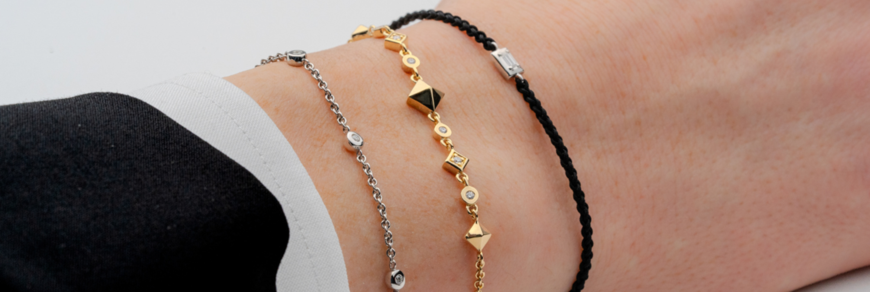 Unisex LANDS layered natural diamond bracelets in gold and silver modern electrum. Spirit ascent, earth ascent ii and ice origin.