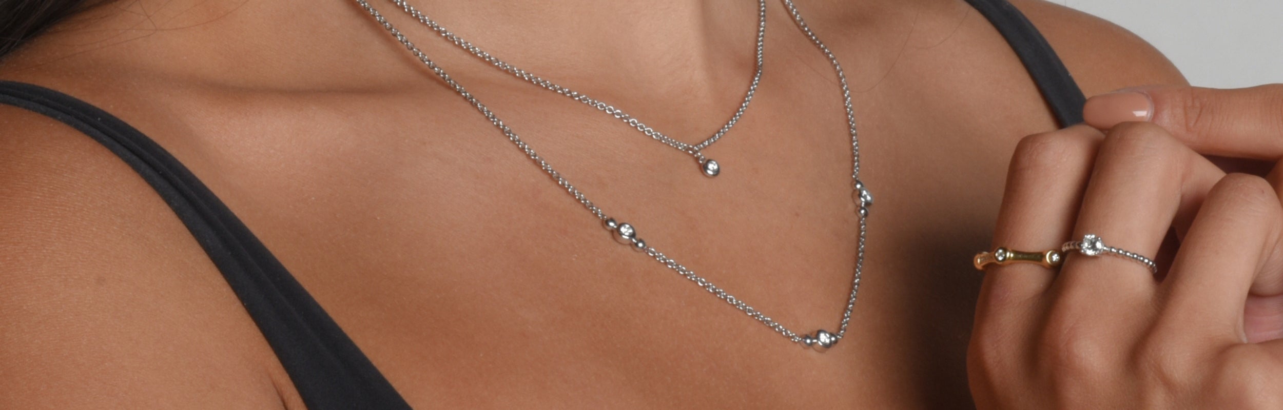 Kateri Lynn wearing Spirit pendants and spirt necklaces set in modern electrum featuring diamonds that glow from gaucho Kué