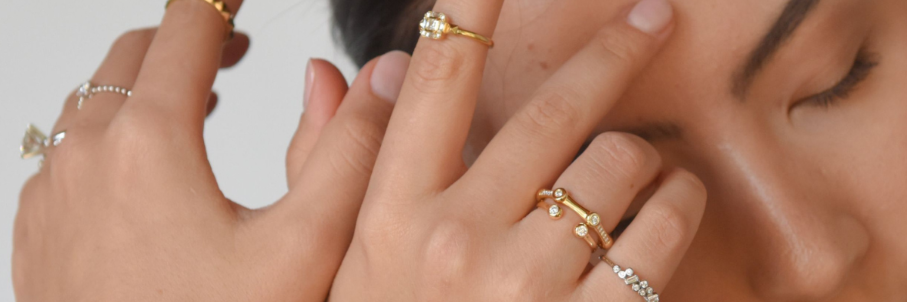 LANDS natural diamond jewelry and rings in modern electrum stacked and layered on female hands