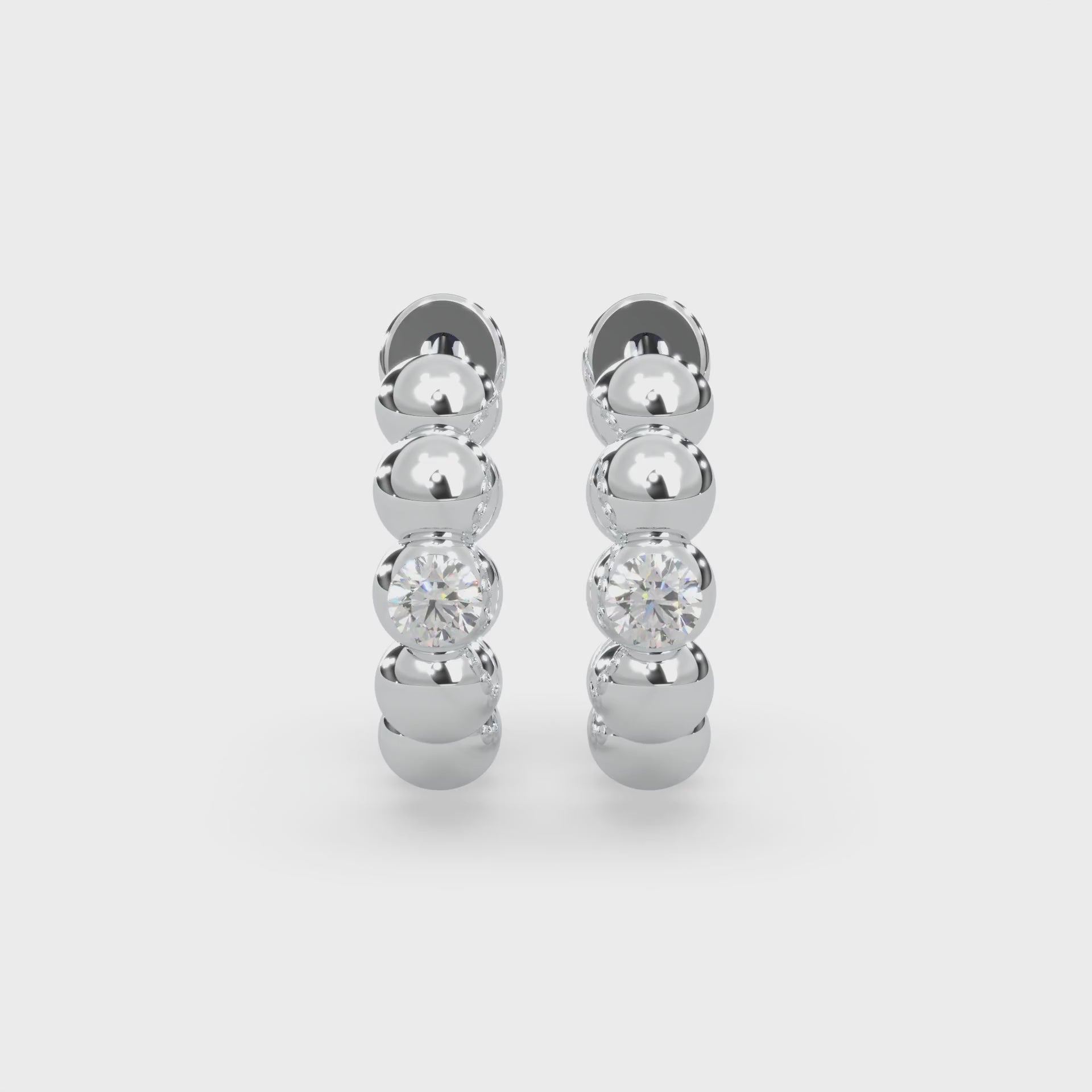 Two round-cut type 2a glowing natural Canadian diamonds. 0.04 carat total weight. Hoop design set in Modern Electrum™. D to H in color and SI clarity and above. Gahcho Kué spirit collection 500 million years old.