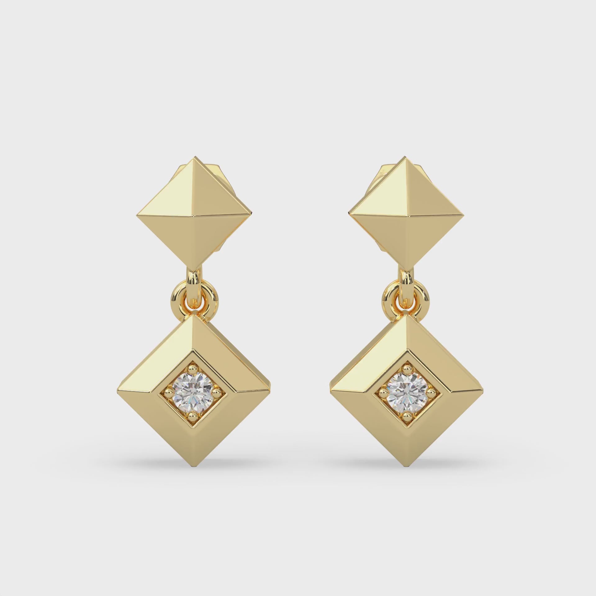 Dangle stud earrings with two round-cut natural Canadian diamonds. 0.07 carat total weight set in Modern Electrum™. Color range from K to Z, with a clarity of SI and above. Ekati mine. 45 to 55 million years old.