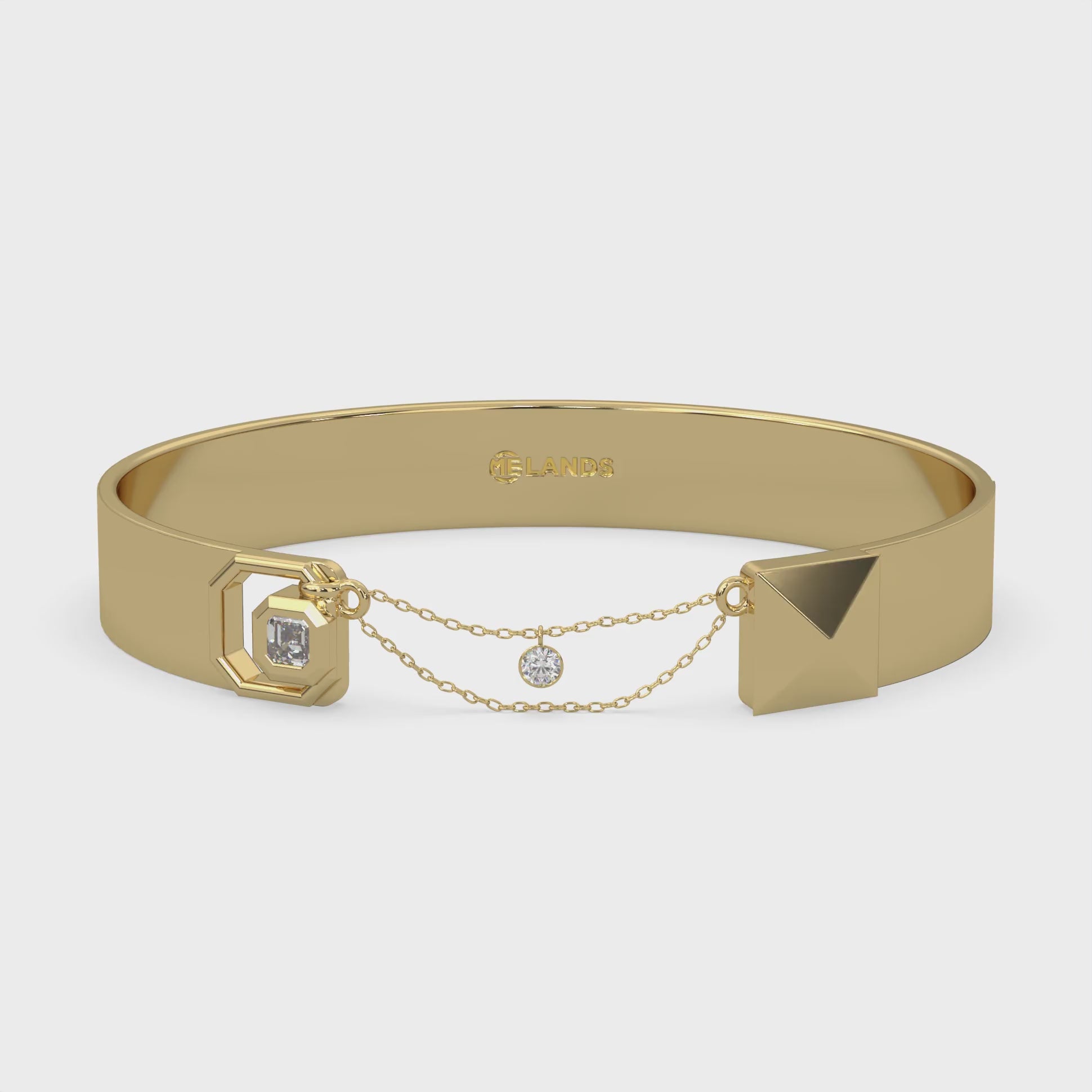 Unisex Bangle diamond bracelet with one square emerald. Wide cuff design set in Modern Electrum™ from Ekati chain closure