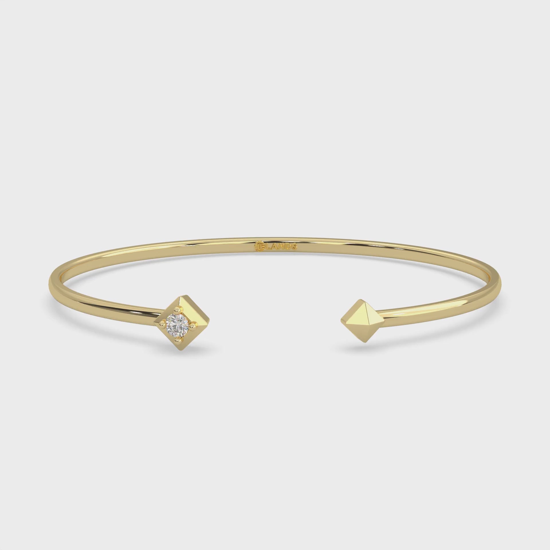 unisex Flex bangle diamond bracelet. One round cut diamond set in Modern Electrum™ from Ekati.